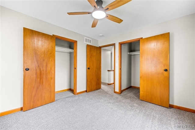 374 Dewey Ave, Buffalo, NY 14214 - unfurnished bedroom with carpet floors, two closets, and a ceiling fan