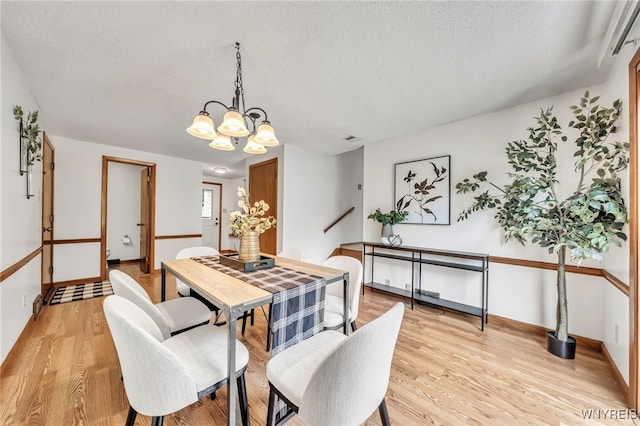 94 N Seine Dr, Cheektowaga, NY 14227 - dining area with a textured ceiling, light wood-type flooring, and a chandelier
