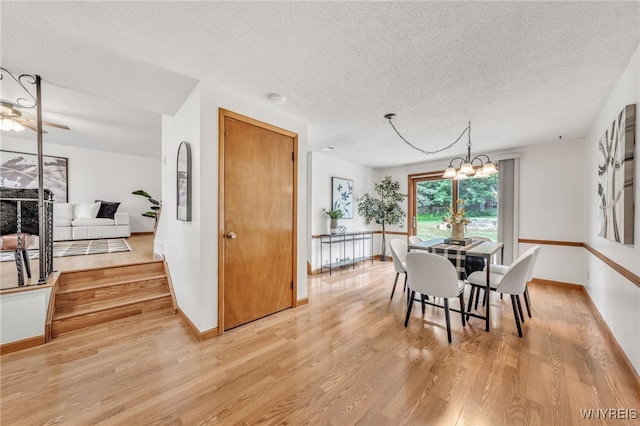 94 N Seine Dr, Cheektowaga, NY 14227 - dining room with a textured ceiling, light wood-style flooring, and a chandelier