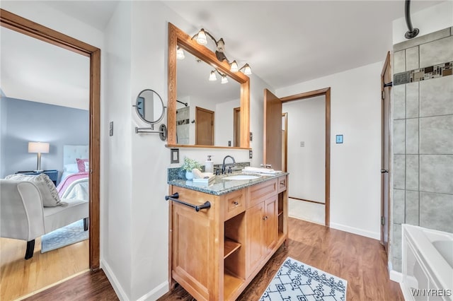 94 N Seine Dr, Cheektowaga, NY 14227 - ensuite bathroom with vanity, a bath, wood finished floors, and a shower