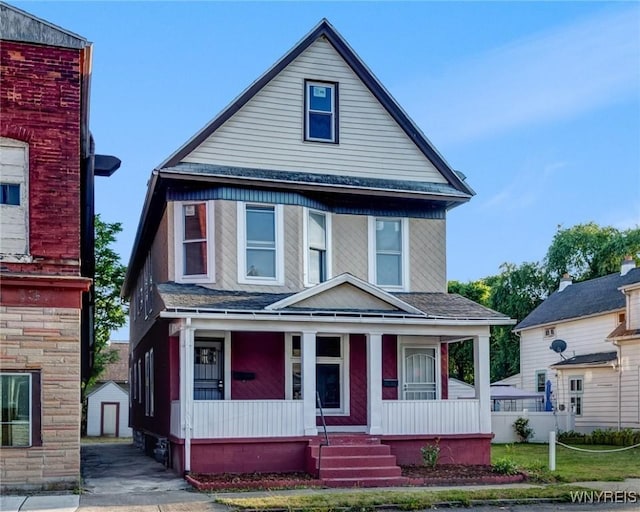 1329 Clinton St, Buffalo, NY 14206 - view of front of house with covered porch, roof with shingles, and an outbuilding