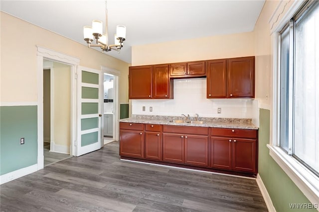 1329 Clinton St, Buffalo, NY 14206 - kitchen featuring a chandelier, hanging light fixtures, dark wood-style floors, and light stone counters
