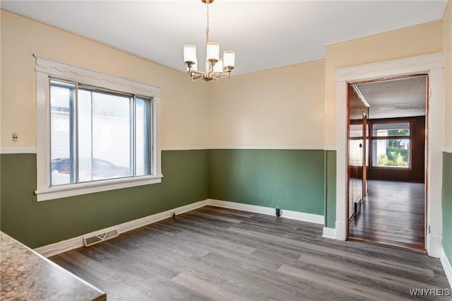 1329 Clinton St, Buffalo, NY 14206 - unfurnished dining area featuring a chandelier and wood finished floors