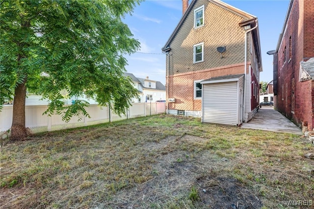 1329 Clinton St, Buffalo, NY 14206 - back of property featuring a fenced backyard and a chimney