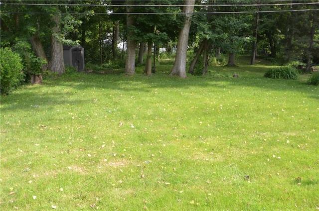 162 Miramar Rd, Gates, NY 14624 - view of grassy yard featuring a shed