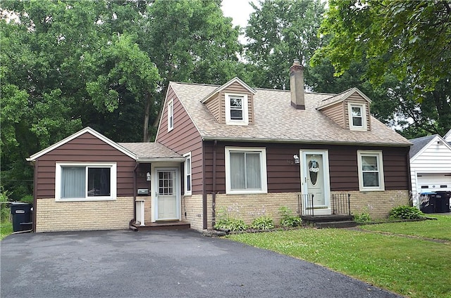 162 Miramar Rd, Gates, NY 14624 - view of front of home with brick siding, a front yard, a chimney, and a shingled roof