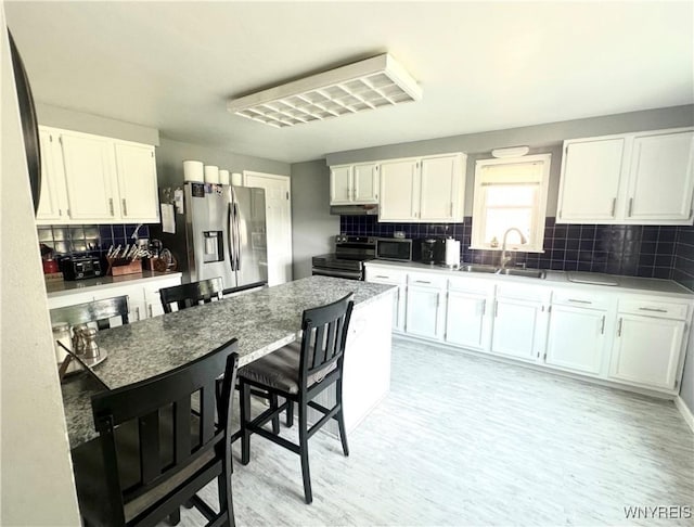 93 Century Dr, West Seneca, NY 14224 - kitchen with stainless steel appliances, white cabinets, backsplash, and light wood-style flooring