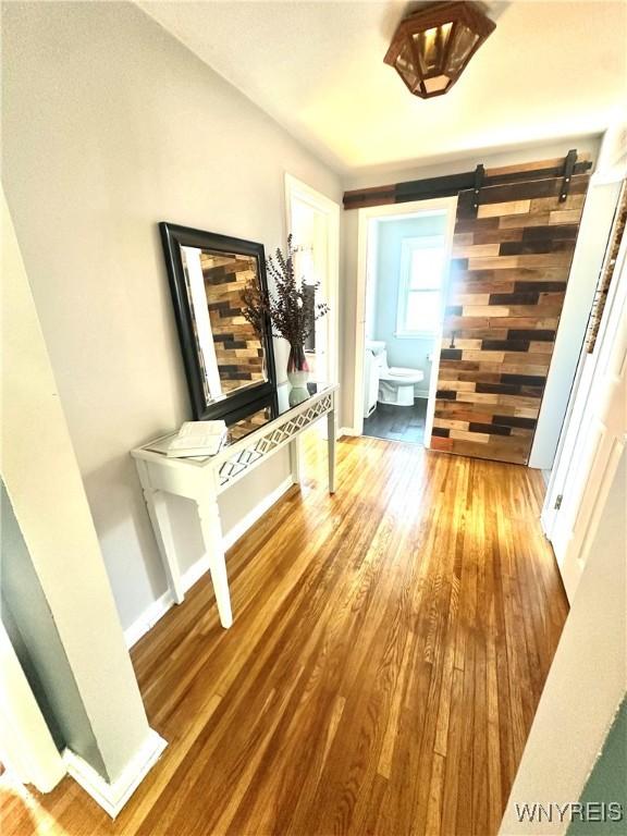 93 Century Dr, West Seneca, NY 14224 - hallway featuring wood finished floors and a barn door