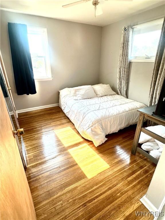 93 Century Dr, West Seneca, NY 14224 - bedroom featuring multiple windows, wood finished floors, and ceiling fan