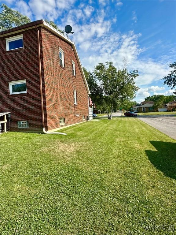 93 Century Dr, West Seneca, NY 14224 - view of home's exterior featuring a lawn and brick siding