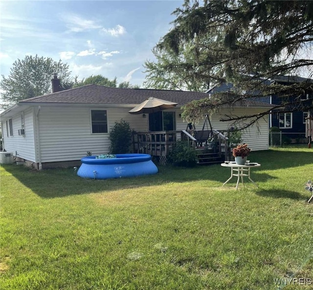 120 Park Lane Cir, Lockport City, NY 14094 - rear view of house featuring a wooden deck, a yard, a chimney, and a shingled roof