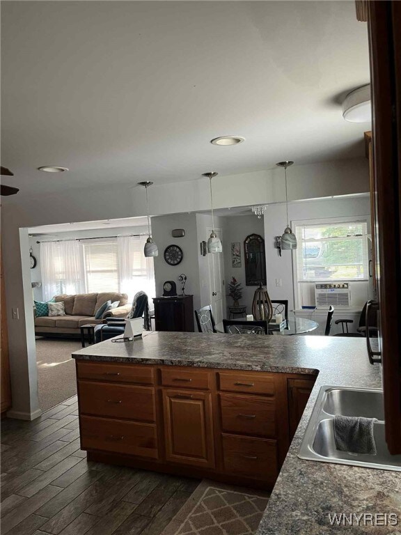 120 Park Lane Cir, Lockport City, NY 14094 - kitchen with cooling unit, dark wood-style flooring, dark countertops, and hanging light fixtures