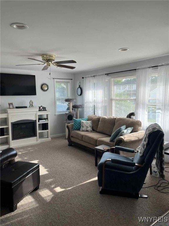 120 Park Lane Cir, Lockport City, NY 14094 - carpeted living room with plenty of natural light, a glass covered fireplace, and a ceiling fan