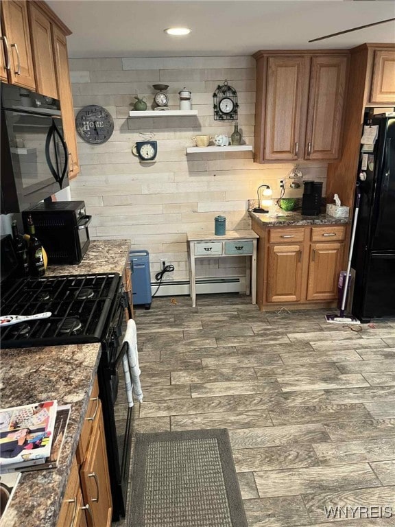 120 Park Lane Cir, Lockport City, NY 14094 - kitchen with black appliances, wood finished floors, baseboard heating, dark stone countertops, and brown cabinetry