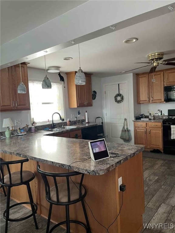 120 Park Lane Cir, Lockport City, NY 14094 - kitchen featuring black appliances, dark countertops, a peninsula, dark wood-style floors, and recessed lighting