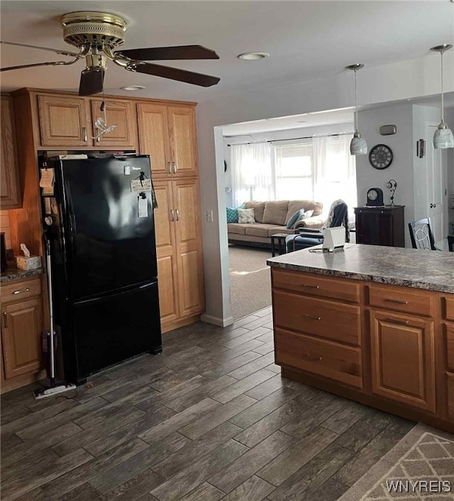 120 Park Lane Cir, Lockport City, NY 14094 - kitchen with freestanding refrigerator, a ceiling fan, dark countertops, dark wood finished floors, and brown cabinets
