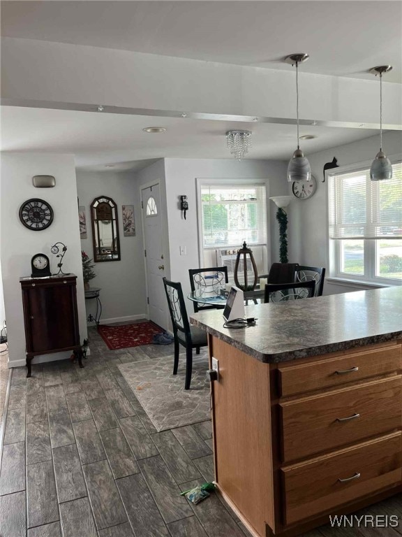120 Park Lane Cir, Lockport City, NY 14094 - kitchen featuring dark wood finished floors, dark countertops, hanging light fixtures, brown cabinetry, and recessed lighting
