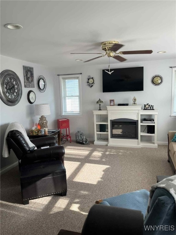 120 Park Lane Cir, Lockport City, NY 14094 - living area featuring carpet flooring, a ceiling fan, and a glass covered fireplace