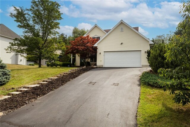 203 Upland Run, Horseheads, NY 14845 - view of property hidden behind natural elements featuring asphalt driveway, a front yard, and a garage