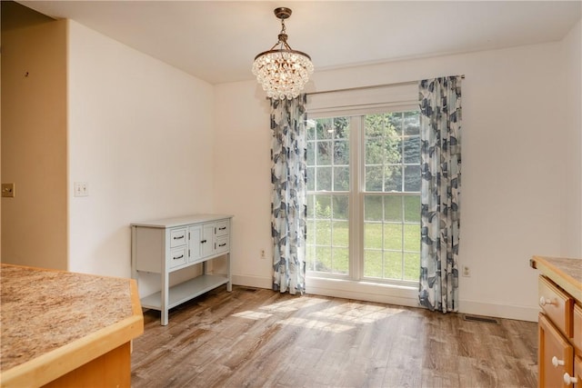 203 Upland Run, Horseheads, NY 14845 - unfurnished dining area featuring light wood-style floors and a chandelier