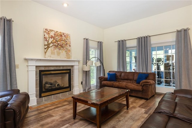 203 Upland Run, Horseheads, NY 14845 - living room with wood finished floors, a tiled fireplace, and recessed lighting