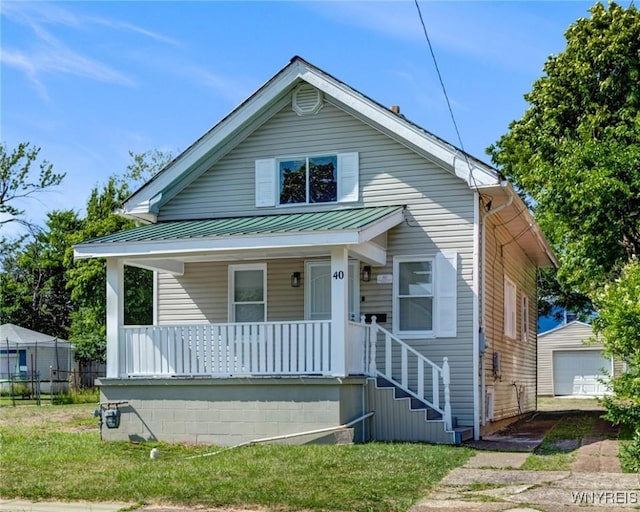 40 Decker St, Buffalo, NY 14215 - bungalow-style home featuring covered porch, a metal roof, a garage, an outdoor structure, and a standing seam roof