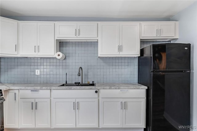 40 Decker St, Buffalo, NY 14215 - kitchen with freestanding refrigerator, white cabinets, and tasteful backsplash