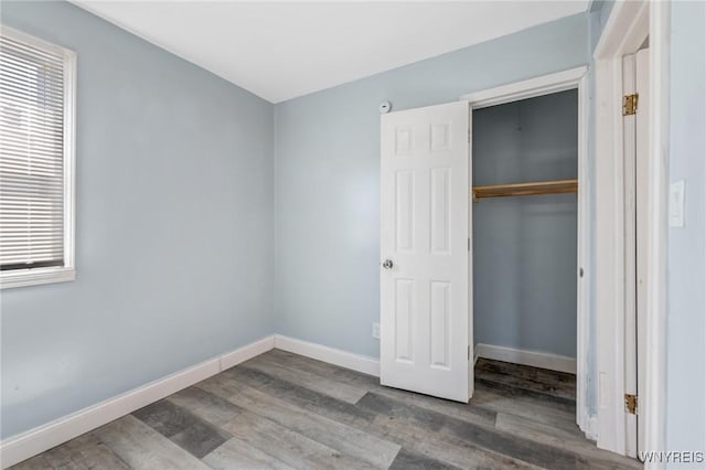 40 Decker St, Buffalo, NY 14215 - unfurnished bedroom featuring wood finished floors, a closet, and multiple windows