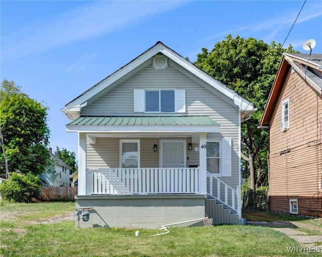 40 Decker St, Buffalo, NY 14215 - view of front of house with covered porch, a metal roof, and a front yard