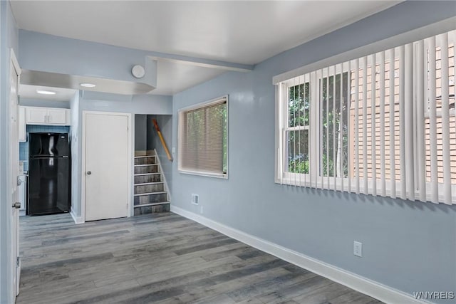 40 Decker St, Buffalo, NY 14215 - unfurnished bedroom featuring freestanding refrigerator, wood finished floors, and a closet