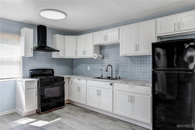 40 Decker St, Buffalo, NY 14215 - kitchen with black appliances, wall chimney range hood, backsplash, and white cabinetry