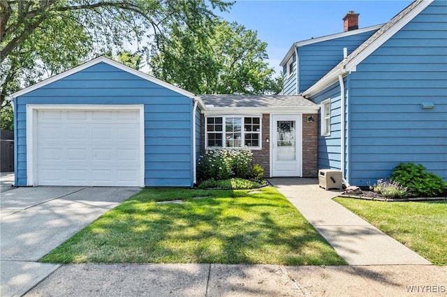 715 Brighton Rd, Tonawanda, NY 14150 - view of front of home with a chimney, driveway, a front yard, stone siding, and a shingled roof
