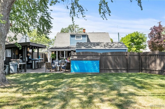 715 Brighton Rd, Tonawanda, NY 14150 - back of property featuring a fenced backyard, a patio, a gazebo, roof with shingles, and a chimney