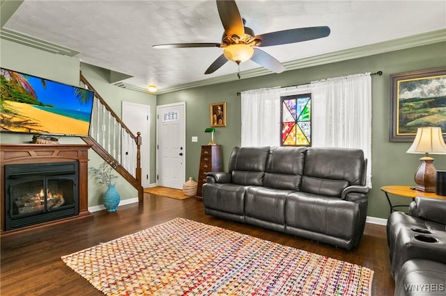 715 Brighton Rd, Tonawanda, NY 14150 - living room with stairway, ceiling fan, wood finished floors, a glass covered fireplace, and crown molding