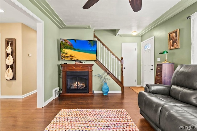 715 Brighton Rd, Tonawanda, NY 14150 - living room featuring a ceiling fan, wood finished floors, stairway, and a lit fireplace