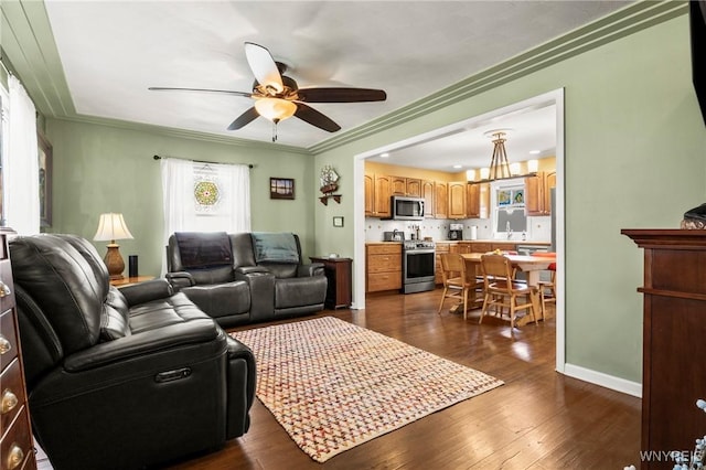715 Brighton Rd, Tonawanda, NY 14150 - living area with a ceiling fan, dark wood-type flooring, and ornamental molding
