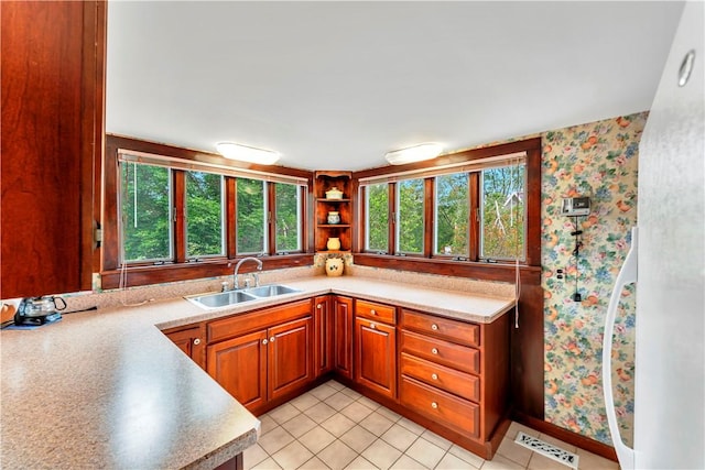 61 Country Pl, Colesville, NY 13813 - kitchen with plenty of natural light, wallpapered walls, light countertops, and brown cabinetry