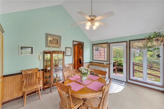 61 Country Pl, Colesville, NY 13813 - carpeted dining space featuring wainscoting, high vaulted ceiling, ceiling fan, and wooden walls