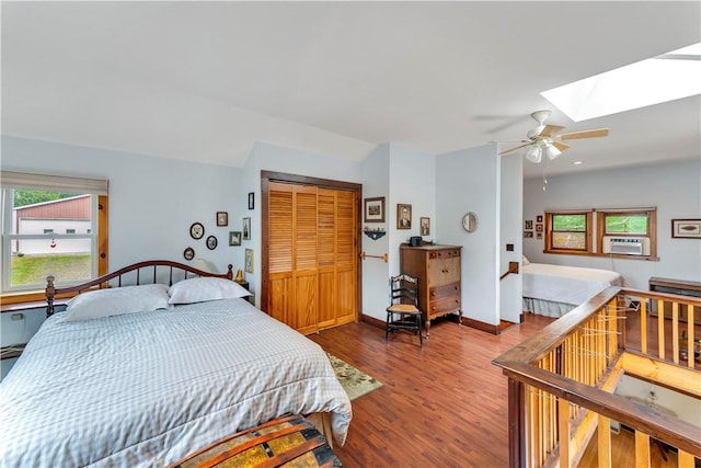 61 Country Pl, Colesville, NY 13813 - bedroom with a skylight, wood finished floors, a closet, cooling unit, and ceiling fan