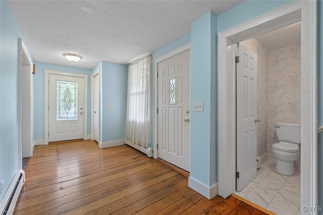 16 Onondaga St, Skaneateles, NY 13152 - foyer entrance featuring a baseboard radiator, a textured ceiling, and light wood-style floors