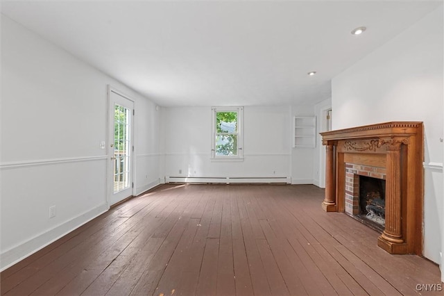 16 Onondaga St, Skaneateles, NY 13152 - unfurnished living room with a baseboard heating unit, plenty of natural light, a brick fireplace, hardwood / wood-style floors, and recessed lighting