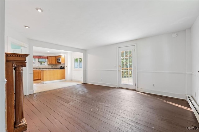 16 Onondaga St, Skaneateles, NY 13152 - unfurnished living room with light wood-type flooring, a baseboard heating unit, and recessed lighting