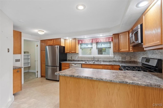 16 Onondaga St, Skaneateles, NY 13152 - kitchen featuring stainless steel appliances, a peninsula, tasteful backsplash, dark countertops, and recessed lighting