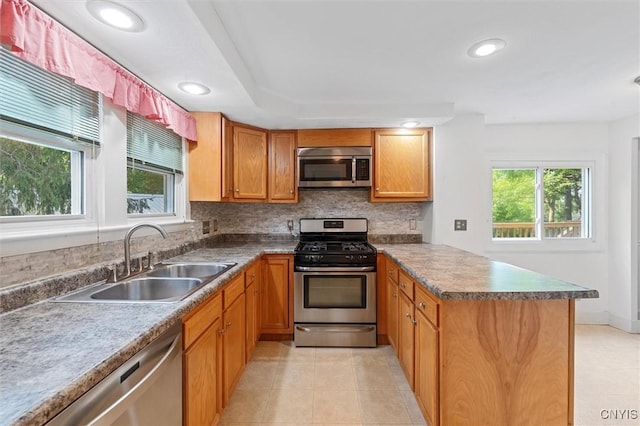 16 Onondaga St, Skaneateles, NY 13152 - kitchen with appliances with stainless steel finishes, a peninsula, plenty of natural light, light tile patterned flooring, and recessed lighting