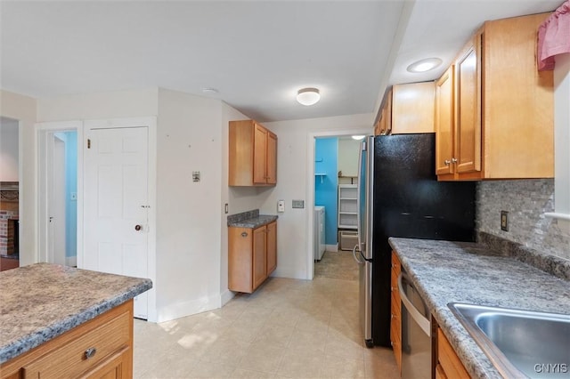 16 Onondaga St, Skaneateles, NY 13152 - kitchen featuring dishwasher, washer / dryer, decorative backsplash, and light tile patterned floors