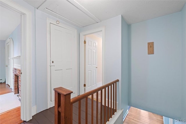 16 Onondaga St, Skaneateles, NY 13152 - hallway with attic access, wood finished floors, and an upstairs landing