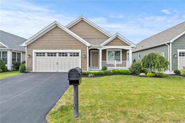 29 Raine Dr, Amherst, NY 14221 - view of front facade with a porch, an attached garage, asphalt driveway, and a front lawn