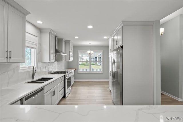 29 Raine Dr, Amherst, NY 14221 - kitchen with appliances with stainless steel finishes, light stone countertops, backsplash, recessed lighting, and light wood finished floors