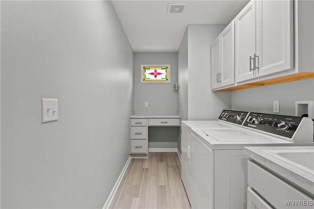 29 Raine Dr, Amherst, NY 14221 - laundry area featuring washer and dryer, cabinet space, and light wood-style flooring