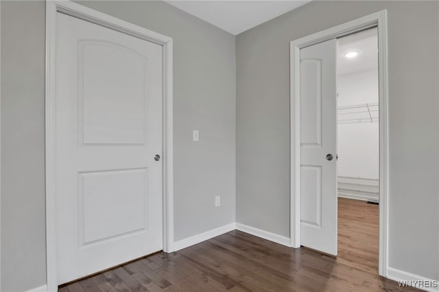 29 Raine Dr, Amherst, NY 14221 - empty room with dark wood finished floors and baseboards